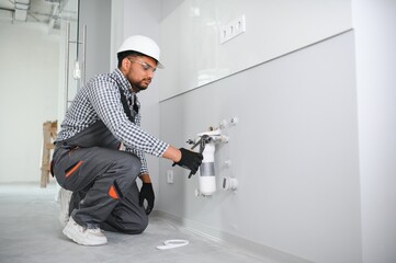 plumber installing water equipment - meter, filter and pressure reducer