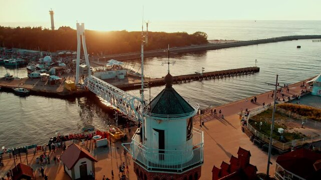 Lighthouse and foot bridge in port