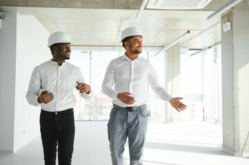 engineers team are discussing while inspecting at construction site