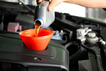 Refueling and pouring oil quality into the engine motor car Transmission and Maintenance Gear .Energy fuel concept