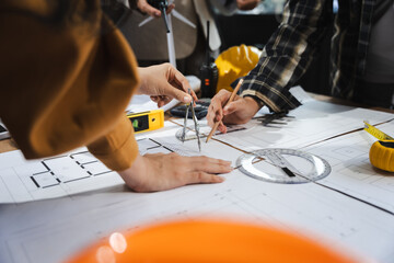 Engineer teams meeting working together wear worker helmets hardhat on construction site in modern city.Asian industry professional team..