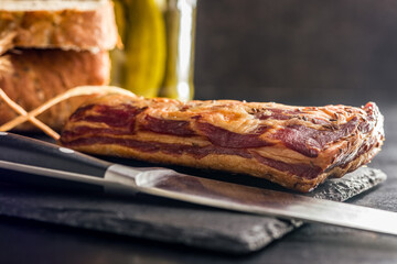 Smoked and Cured Pork Belly With Caraway Seeds on Cutting Board.