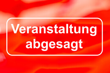 Schriftzug VERANSTALTUNG ABGESAGT vor rotem Hintergrund