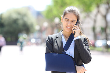 Convalescent executive talking on phone in the street