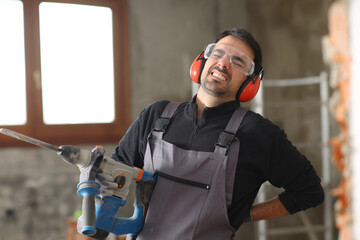 Construction worker suffering back ache working in a house