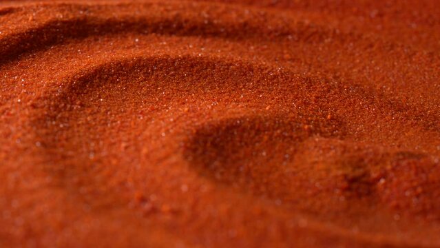Small bright orange crystals of potassium dichromate, close up, abstract colorful background