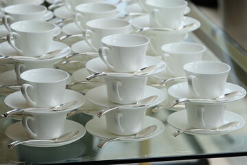 White tea cups stand in a row on the table