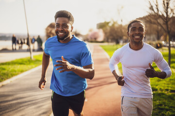Fototapeta premium Two african-american friends are jogging in the city.
