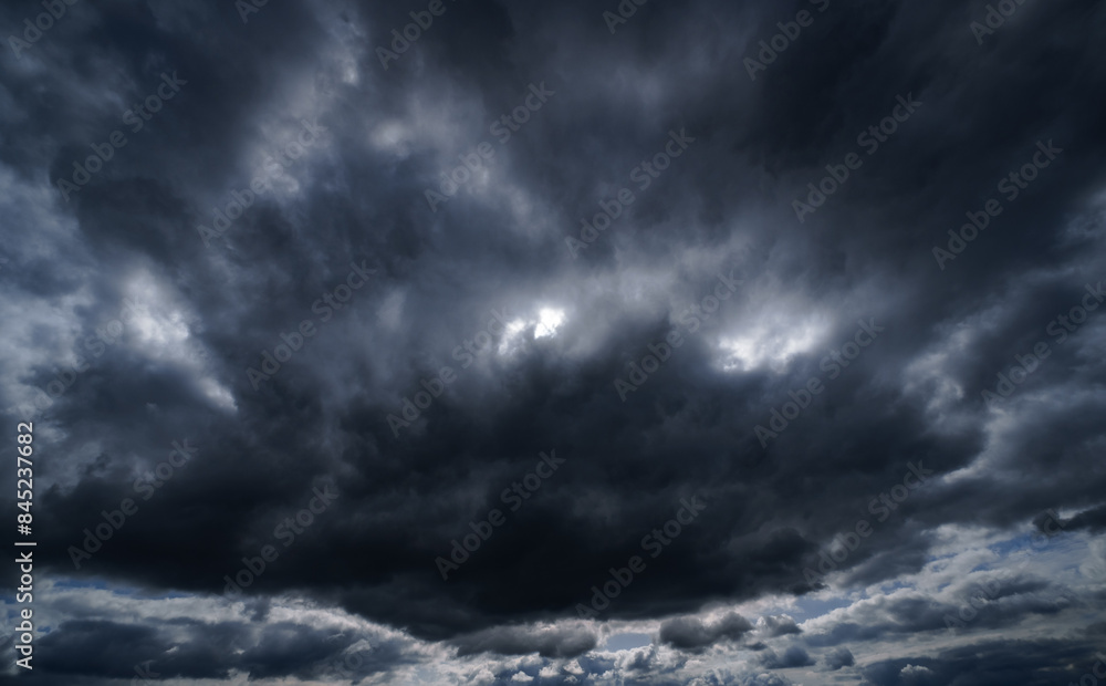 Wall mural dark dramatic sky with stormy clouds before rain as abstract background, extreme weather