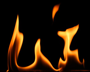 fire on a black background, burning and hot flames, close view