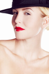 Shes in a sexy mood. Beauty shot of a young woman wearing a hat and red lipstick.