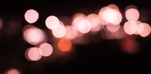 defocused christmas lights with pink background
