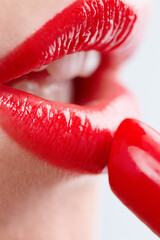 Woman, gloss and mouth for red lipstick in studio, makeup and cosmetics for care on white...