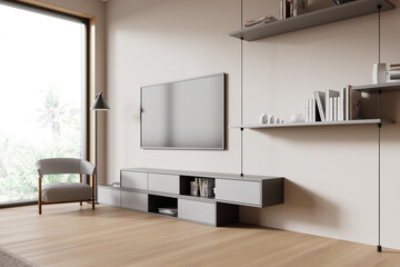 Beige home chill room interior with tv console and armchair on hardwood floor