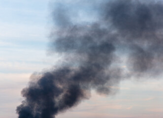 Black smoke from a fire against the sky