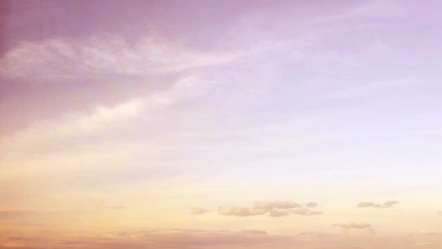 Lightly pink sky at sunset. Clouds in warm colors. Summer landscape with cloudy sky. Calm background on the theme of relaxation and romance.