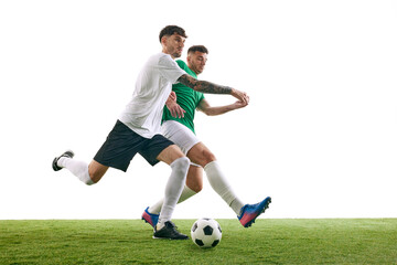Competitive moment on soccer field as player in white blocks player in green's attempt to kick the ball against white background. Concept of professional sport, championship, final match, movement. Ad