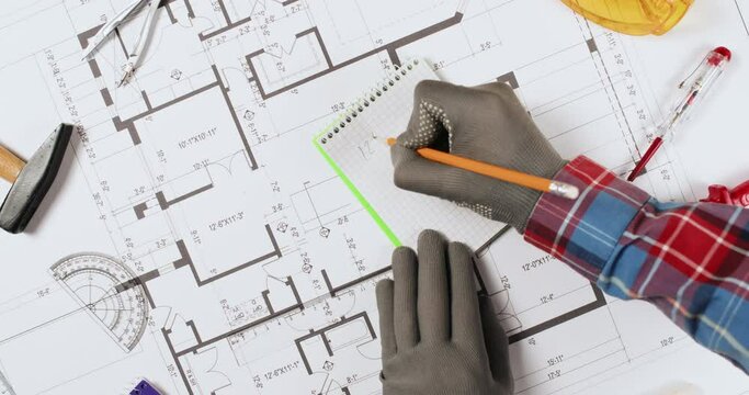 Builder counts square measuring apartment drawing with protractor upper view. Engineer inspects floor plan of apartment house in office