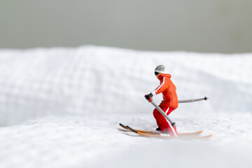 A miniature figurine of a skier dressed in vibrant winter gear. This image is perfect for themes...