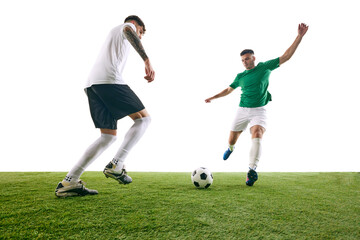Player in white executes defensive move, challenging player in green's advance during soccer game on green lash playground against white background. Concept of sport, championship, match, movement. Ad