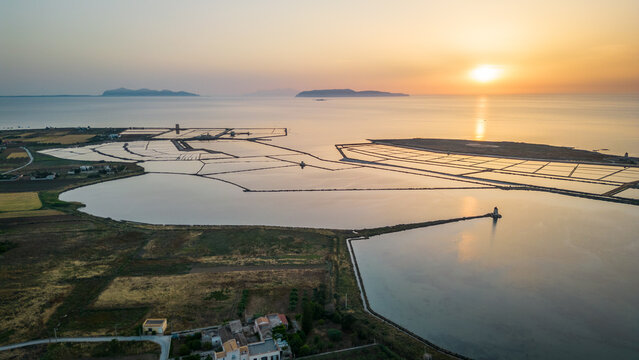 aerial view at sunset of trapani sicily salt pond with Aegadian Islands at distance 