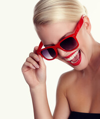 Woman, laughing and sunglasses for trendy in studio with makeup, lipstick and mockup space. Happy, model girl and eyewear for cosmetics, fashion and aesthetics by white background for retro or style