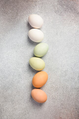 Raw colored chicken eggs. The food is enriched with protein. Creative photo. Close up.