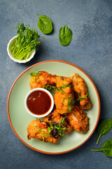 Buffalo chicken wings with sweet chili sauce. Close up. Top view.