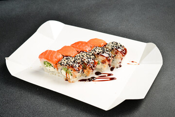Japanese salmon and eel sushi rolls with Philadelphia cheese. Food delivery. close up