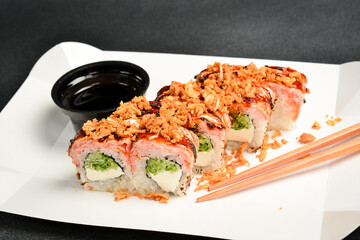 Japanese salmon set menu in paper transparent box. Side view, close-up.