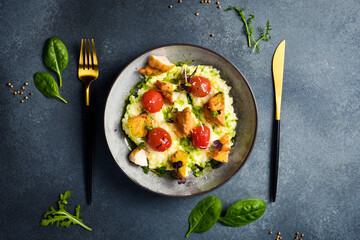 Risotto with chicken fillet and cherry tomatoes. In a plate. Restaurant dish. Close up.