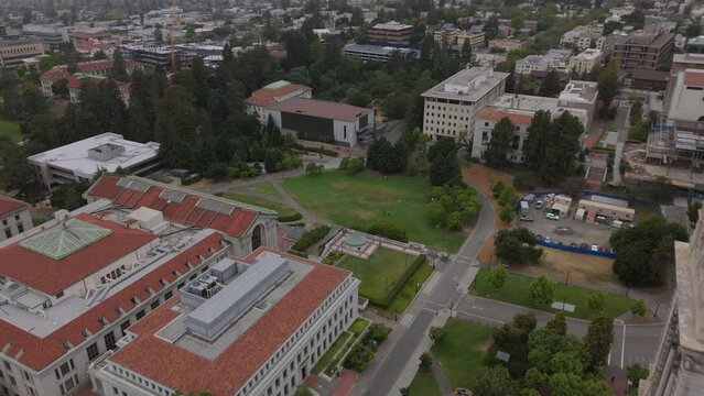 aerial view of UC Berkeley campus flying backward past Campanile tower