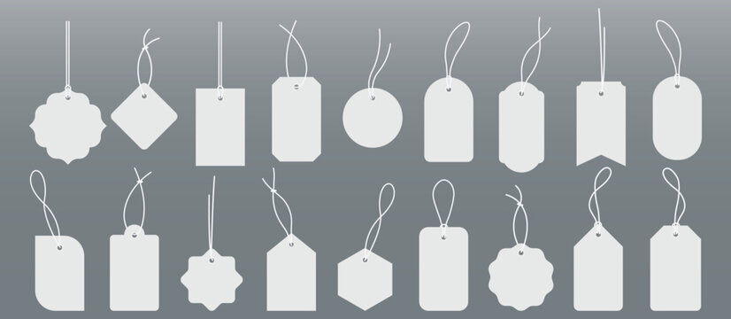 Blank price tags with strings hang against gray.Suitable for retail, pricing, sales, discounts, promotions, merchandise, multipurpose design projects.