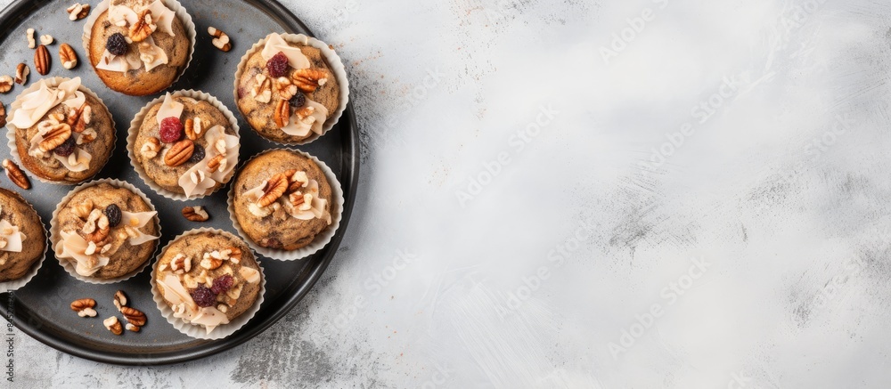 Poster Top view of healthy banana muffins with oatmeal walnuts and cinnamon in baking form on a gray concrete background creating a copy space image