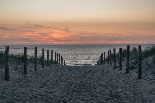 Netherlands, South Holland,KatwijkaanZee,Fenced beach at dusk