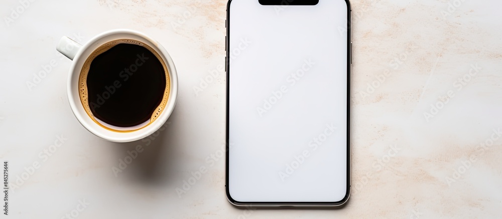 Poster top view of a smartphone coffee cup and notepad placed closely together in a visually appealing comp