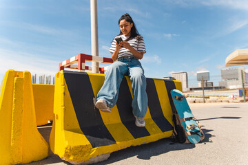 Young woman using mobile phone on sunny day
