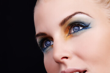 Naklejka premium Woman, beauty and eyeshadow in studio, eyes and cosmetics for face on black background. Female person, color and creative skincare or foundation, self care and eyebrow treatment or dermatology shine