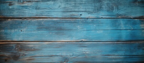 Fototapeta premium A vintage grunge wood surface with a beautiful and faded blue background offers a central area for your text or image in this copy space image
