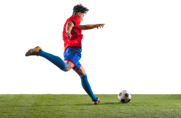 Back view photo of young soccer football player kicking ball with his leg. Man training in uniform on grass flooring against transparent background. Concept of championship, action, team sport game