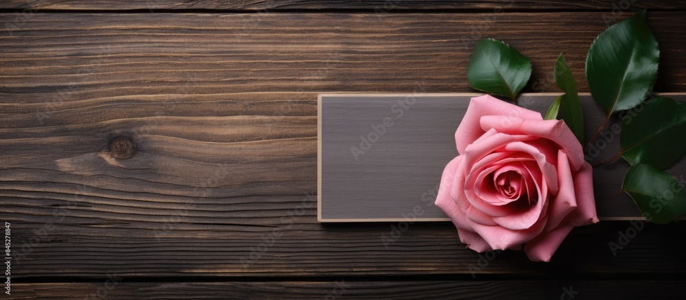 Aufkleber A rose flower is beautifully displayed on a wooden background with a frame surrounding it creating a serene and captivating copy space image