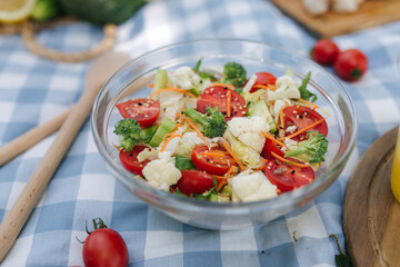 Fresh vegan salad outdoors on blue checkered napkin. Vegan food concept outdoor