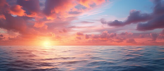 Fototapeta premium A serene ocean at sunset adorned with vibrant clouds against a sky backdrop The calm sea blends harmoniously with the colors of a sunrise sky. Creative banner. Copyspace image