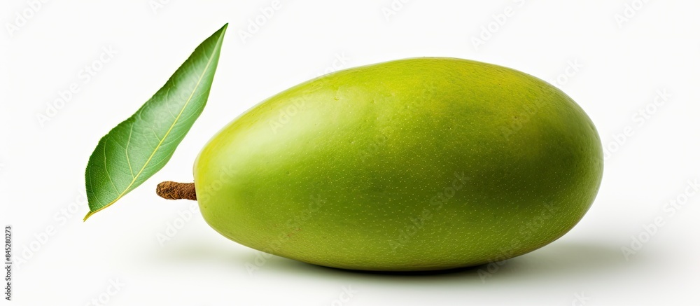 Poster a single raw green mango with its stem is captured in a close up view the mango symbolizing natural 