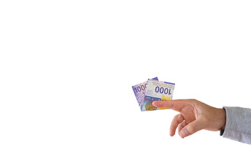 One 1000 Swiss francs cash banknote or bill held by Caucasian male hand. Close up studio shot, white background