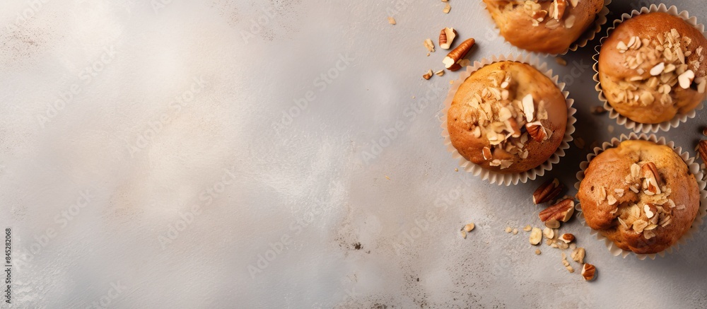 Aufkleber Top view of healthy banana muffins with oatmeal walnuts and cinnamon in baking form on a gray concrete background creating a copy space image
