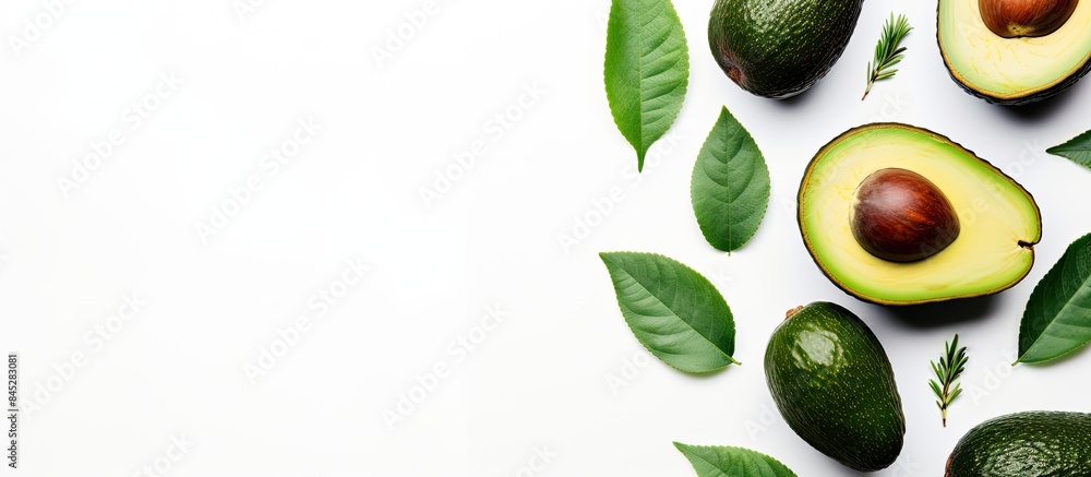 Aufkleber top view of a white background with a fresh ripe avocado accompanied by green leaves ideal for flat 