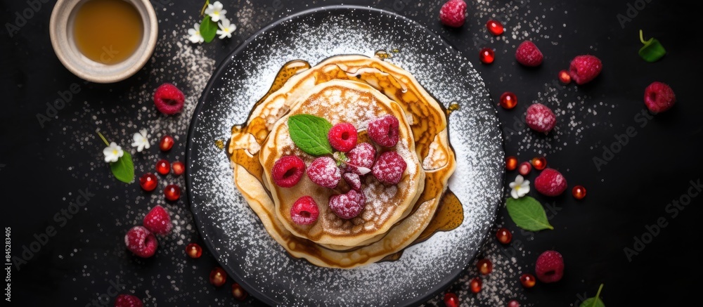 Poster top view of a delightful flat lay featuring homemade pancakes topped with gooey honey juicy raspberr