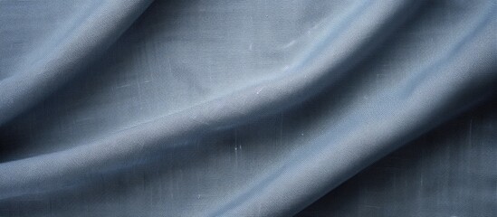 Fototapeta premium A textured gray fabric background made of linen or cotton showcasing the woven texture of a blue gray cloth It s a natural and eco friendly textile copy space image