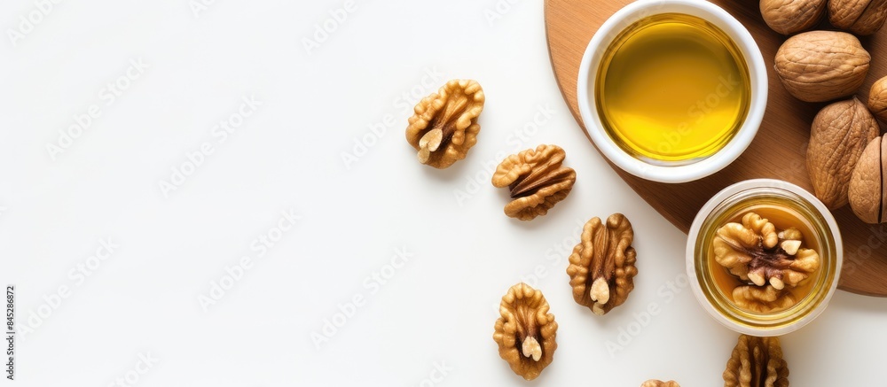Aufkleber a top down view of a jar of walnut oil placed near a bowl of walnuts on a white background offering 